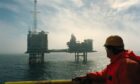 A worker looks out at BP's Etap platform in the North Sea.