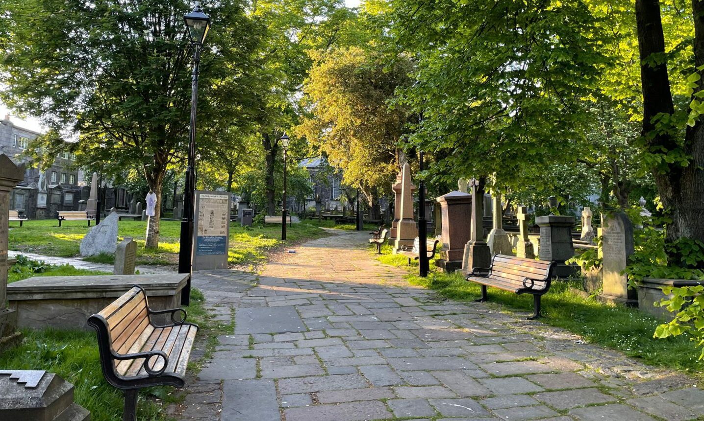 Walkway and benches inside St Nicholas graveyard.