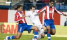 Derek Young (centre) is crowded out by Atletico Madrid duo Eller (left) and Cleber Santana. Image: SNS