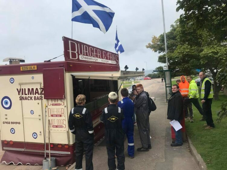 A photo of the van with customers outside. 