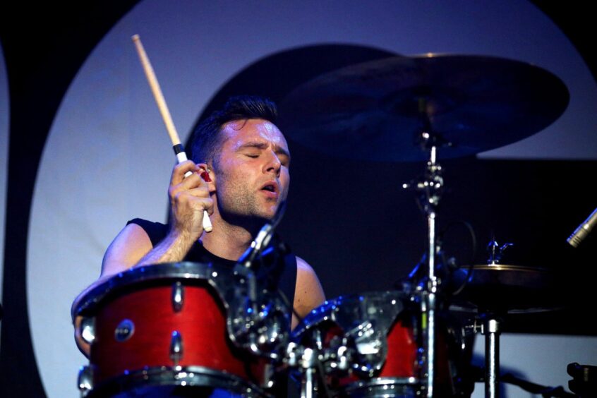 Harry Judd, McFly band member, playing the drums on stage in Manchester.