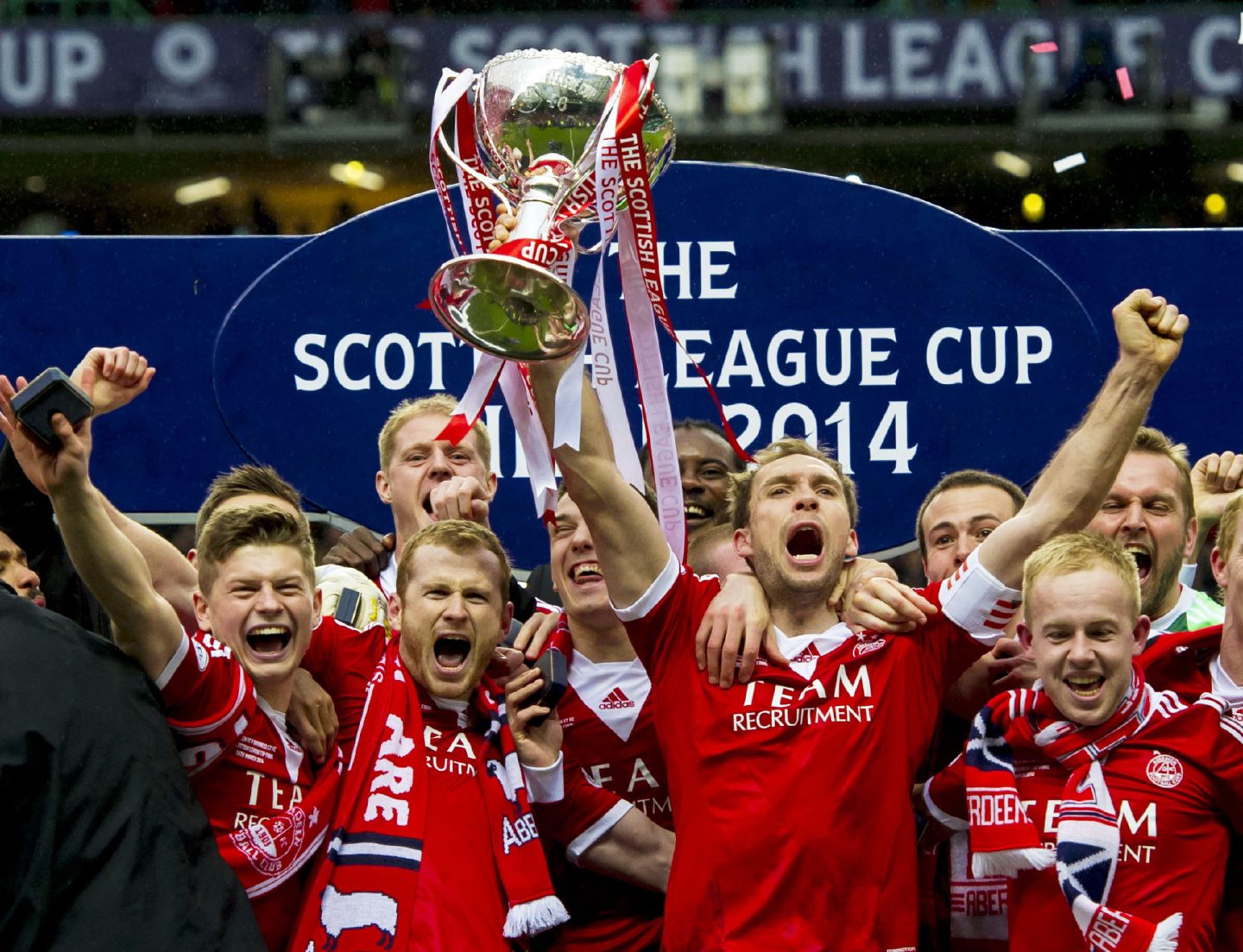 Russell Anderson and his Aberdeen team-mates celebrate win with Scottish League Cup trophy in hand in 2014.