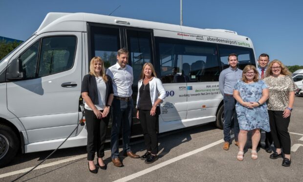 MSPs Jackie Dunbar and Liam Kerr with Aberdeen International Airport's new electric bus and AIA staff who have been part of the bus project.
