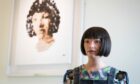 Ai-da the robot near her self portrait during a photo call for the London Design Biennale at Somerset House in London this week. Image: James Manning/PA Wire.