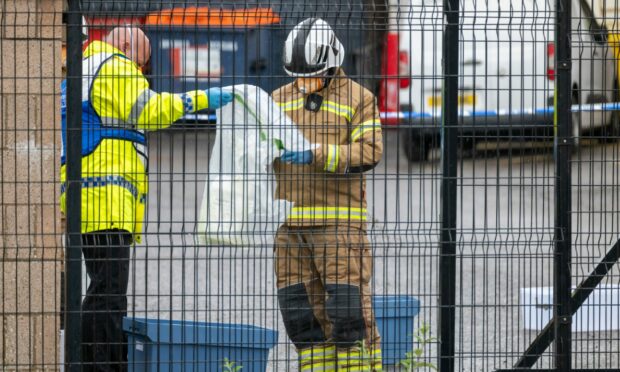 Crews were spotted bagging up materials and placing them in blue containers. Image: Jasperimage.