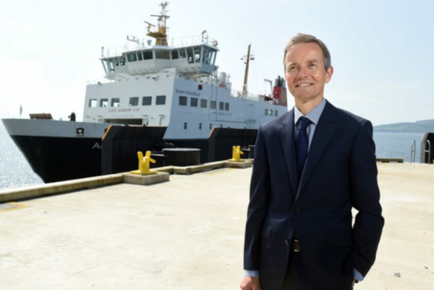 omes just weeks after Robbie Drummond, CalMac chief executive standing and smiling in front of a CalMac vessel.