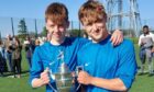 Grammar captain Finlay Williams and goalscorer Josh Davidson with the CNR International League S3 trophy. Image: Walter Craig