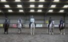 Students on horses in UHI North Highland's indoor yard