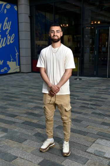 Man in khaki cargo trousers and a beige T-shirt.