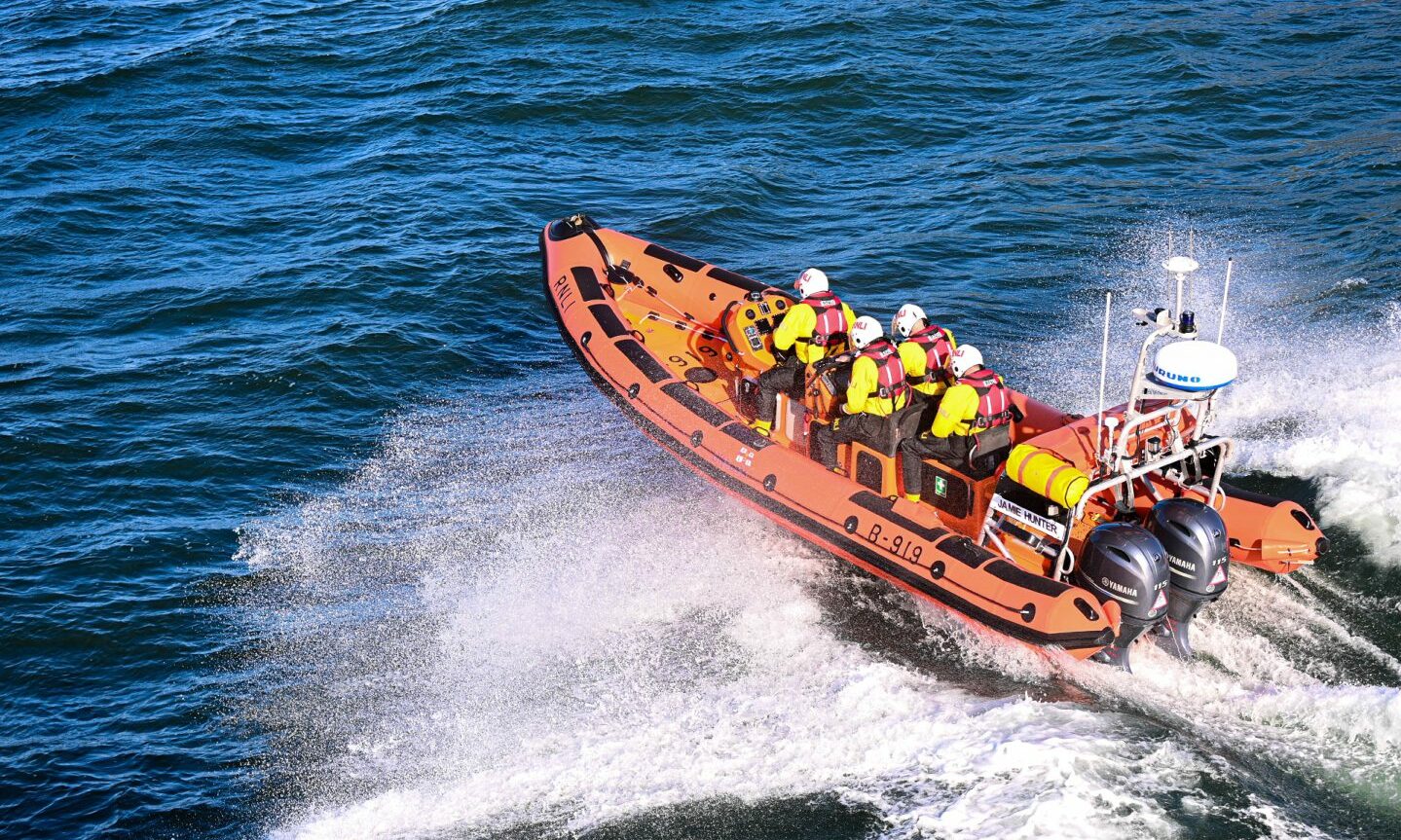 A crew in action on a life boat at sea