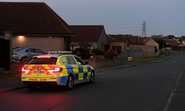 A police car parked on a road.