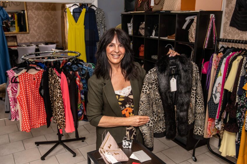 Jane Taylor-Ross holds a preloved designer jacket in her Tarves store, House of Jane.