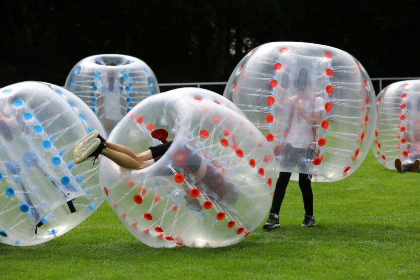 People playing with some zorbs.