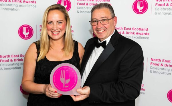 Amity Fish Company boss Jimmy Buchan and Julie Coutts, the firm's head of business development and operations manager, with the e-commerce award at the big food and drink bash. Image: Amity Fish Company