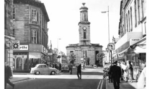 Looking down Elgin High Street in black and white photo.
