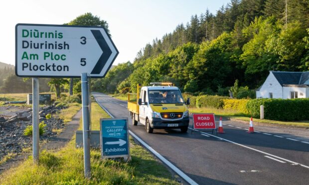 A road maintenance vehicle and a road closure sign block the path of the A87 following a collision.