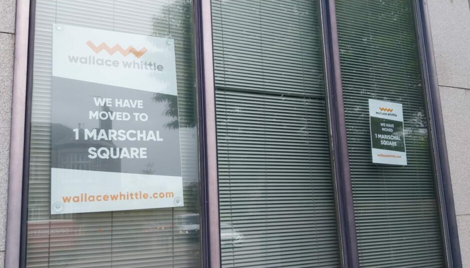 Signs on the windows of the former Wallace Whittle office explain the firm has moved to 1 Marschal Square