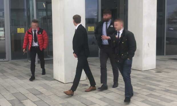 George Culley turns his face from the camera as he leaves court flanked by supporters following his guilty plea. Image: DC Thomson