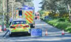 Police and paramedics were seen at the scene of the crash in Lossiemouth.