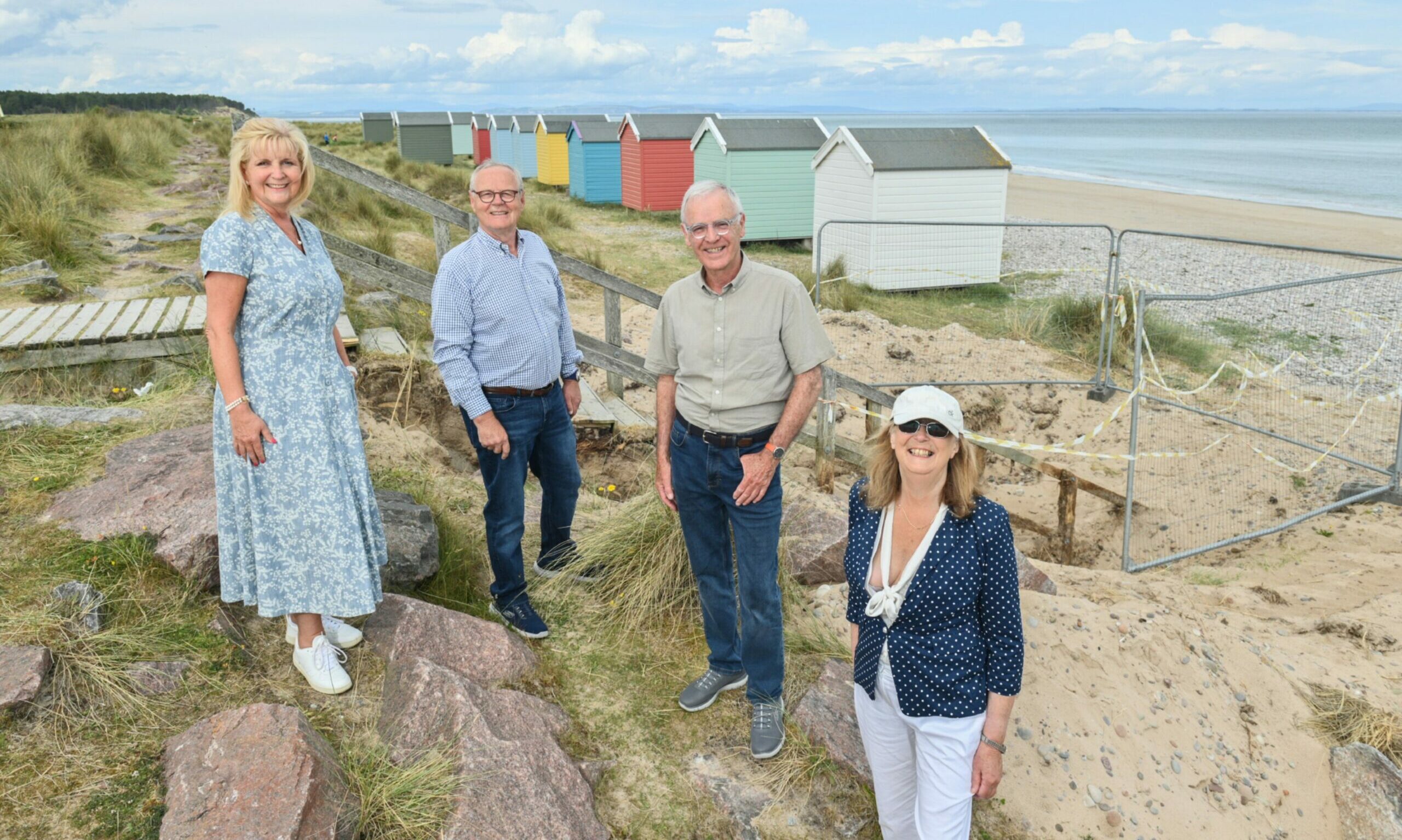 Lorraine and Bill Budge, Sam Russell Chair of FRA and Christine Hunt Chair of the Findhorn village conservation group, at the top of the steps with beach huts in background. 