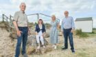 Sam Russell, chairman of Findhorn Residents Association, Christine Hunt, chairwoman of the Findhorn Cillage conservation group, Lorraine and Bill Budge, co-founders Budge Foundation, stood on the beach at the foot of steps sealed off with wire fencing.