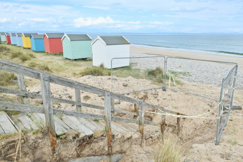 View of Findhorn beach with colourful huts.