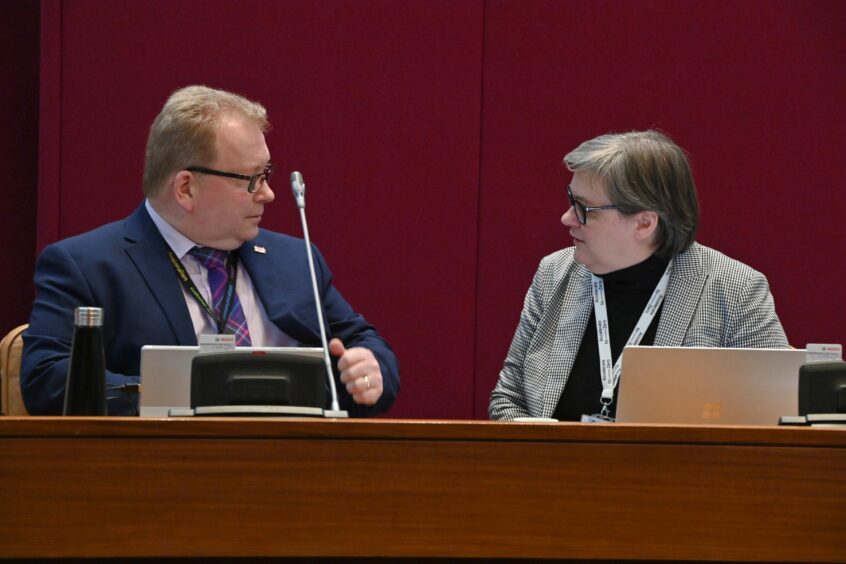 Jonathan Belford takes his seat next to Aberdeen City Council chief executive Angela Scott ahead of March's budget meeting. He is interested in public opinion, and has launched a survey ahead of next year's spending plans being set. Image: Kenny Elrick/DC Thomson