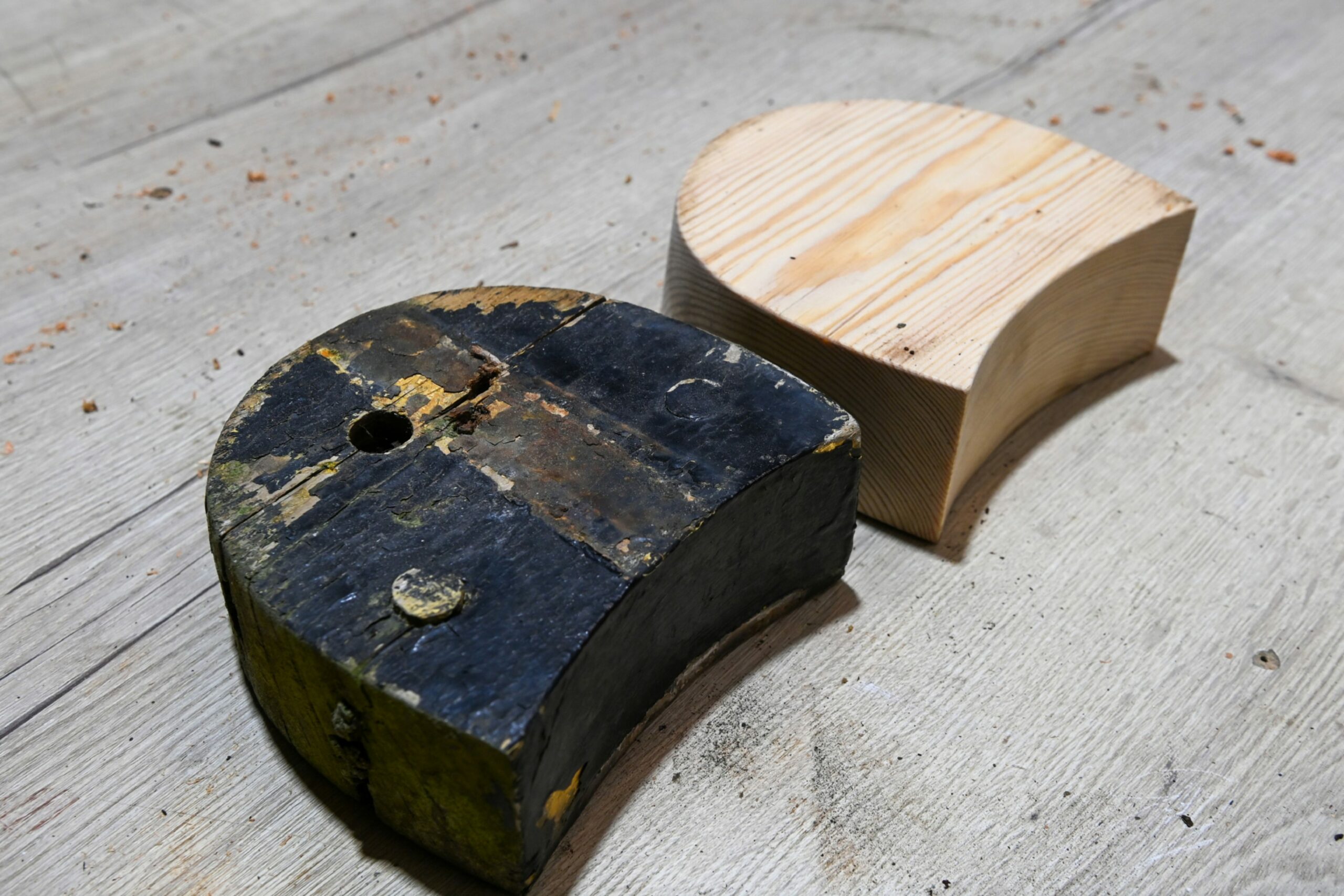 The old and new heel side by side. The old one black, the new with clean wood. 