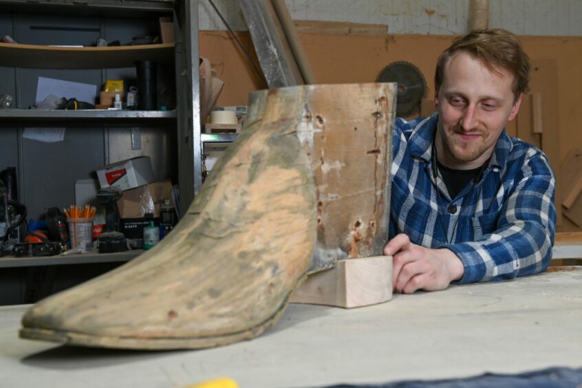Roberts adding the new wooden heel to the boot