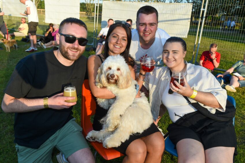 A family with their dog enjoying a beer at the Midsummer Beer Happening. 