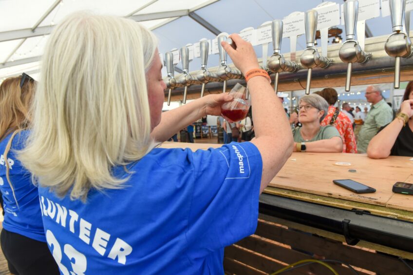 Bartender pouring a beer on the first day of the Midsummer Beer Happening.
