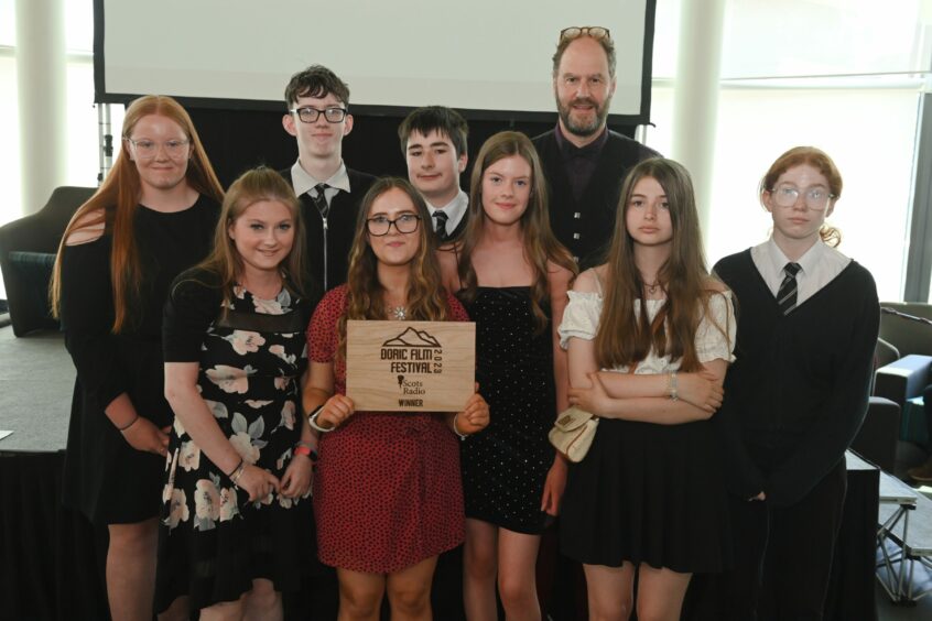 Banff Academy pupils stand with their award.