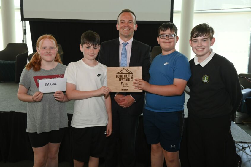 Pupils from Kirkhill Primary School receive their award from Laurence Findlay.