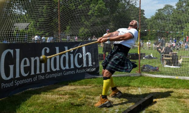Competitors and heavy athletes went head to head at this year's Oldmeldrum Sports and Highland Games as thousands enjoyed themselves in the sun. Image: Kenny Elrick/DC Thomson