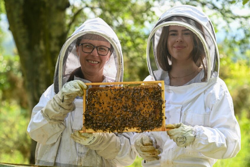 Carnie Bees owners Anna and Kaya Malinowska in beekeeping gear.