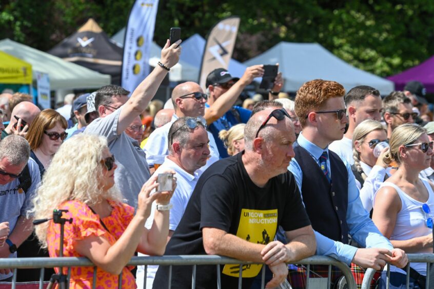 Spectators taking photos of the performances.