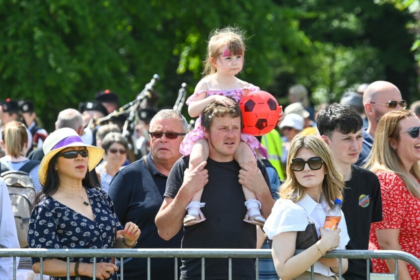 Young girl watches performance.