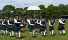 A pipe band performing in front of the bandstand in Duthie Park