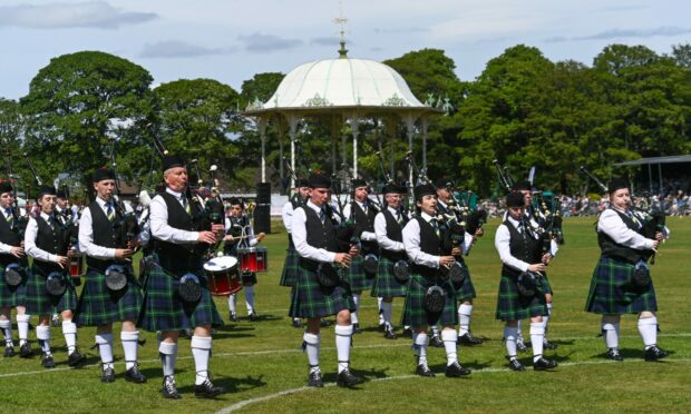 A pipe band performing in front of the bandstand in Duthie Park
