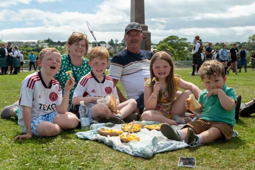 Family poses for pictures at European Pipe Band Championships in Aberdeen.