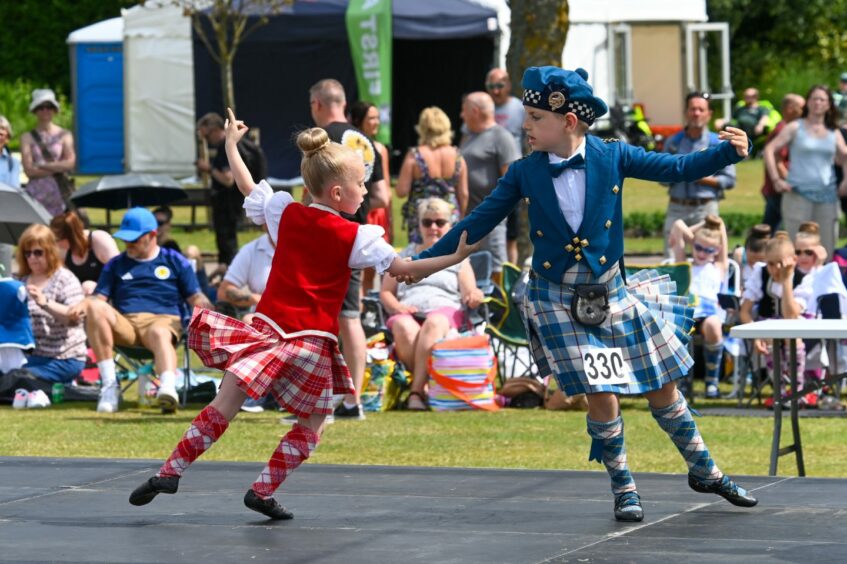 The Highland dancers putting on a performance for the crowd.