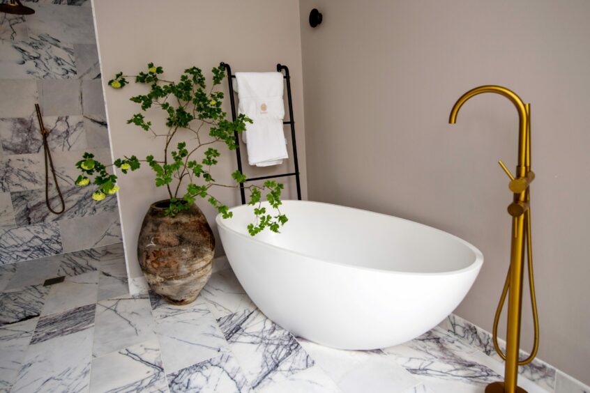 Freestanding baths and marble floors create a luxurious feel
