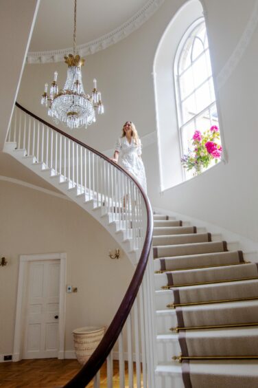 Descending the staircase is an elegant affair