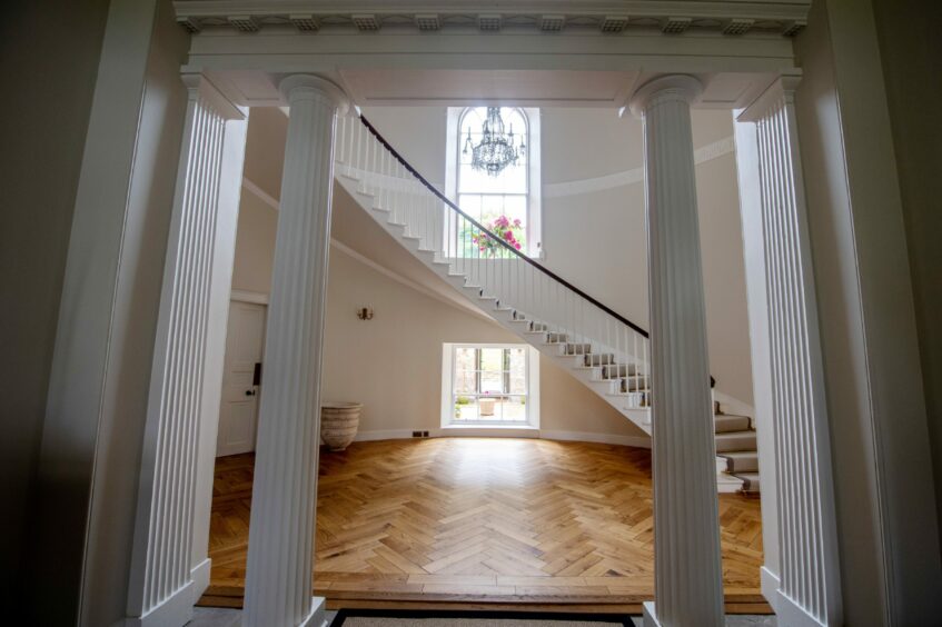 The Greek style pillars beautifully frame the stunning hallway