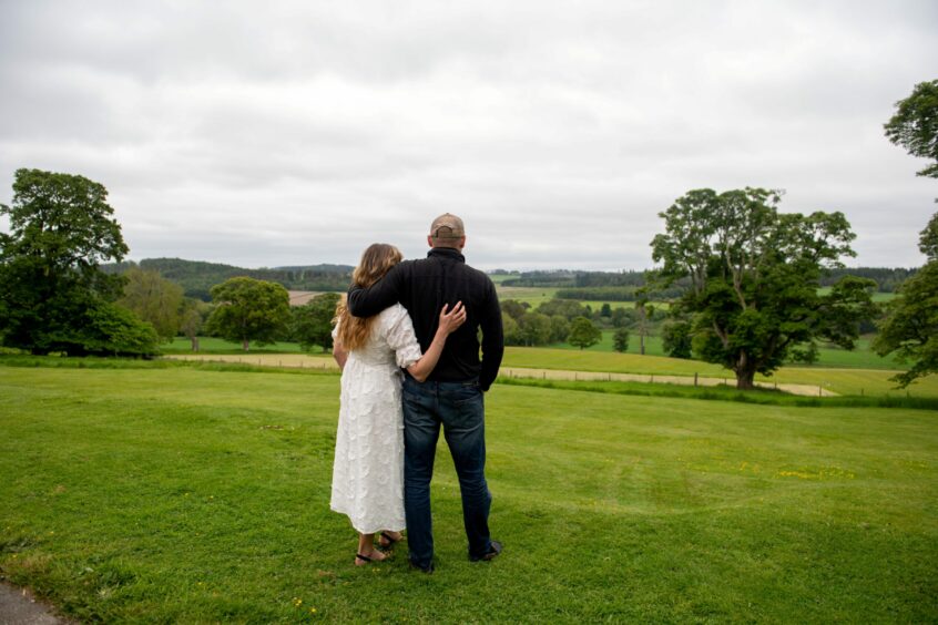 Christina and Dean Horspool in their large garden, looking out at the countryside