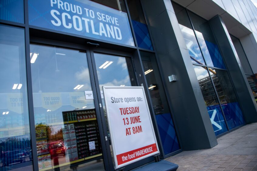 Aberdeen food warehouse with a sign outside reading: "Store opens on: Tuesday 13 June at 8am"