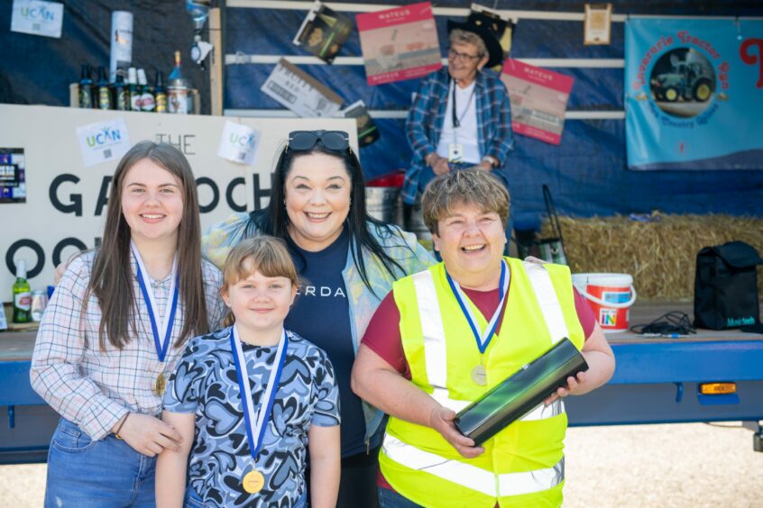 The Emmerdale's Lisa Riley at the Garioch Woolpackers Tractor run with owners of the best done up tractor driver Katie, Abbie and Angie McWilliam. 