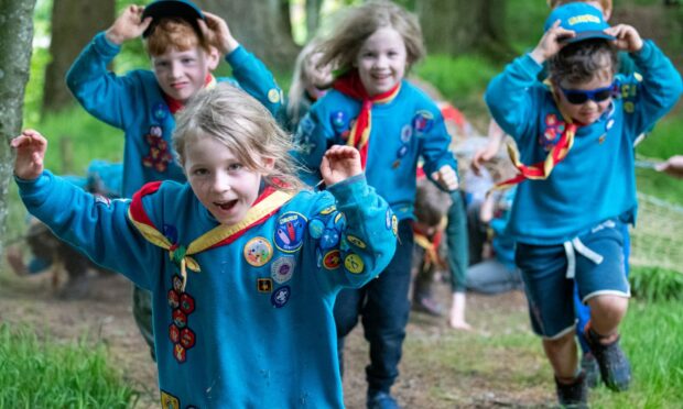 Four children in Beavers uniforms running through Templars' Park