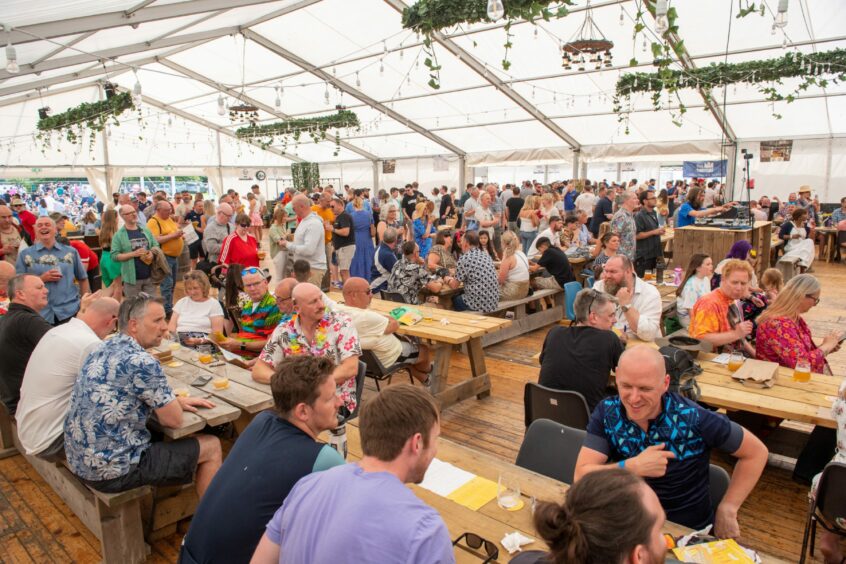 A general view of people enjoying the Midsummer Beer Happening beer festival inside a marquee