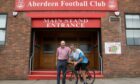 Cyclist Bill Forbes, who pedalled the length of Britain before donating to the Aberdeen FC Community Trust, outside Pittodrie with former Aberdeen player Drew Jarvie.